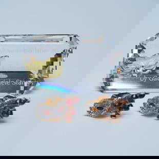 3pc Swarovski Columbine Plaque and Mask Pins: Elegant Swarovski 3pc grouping featuring a Columbine plaque and two intricately designed mask pins. The Columbine plaque, part of the SCS Annual Edition 2000, is a faceted crystal display piece with a