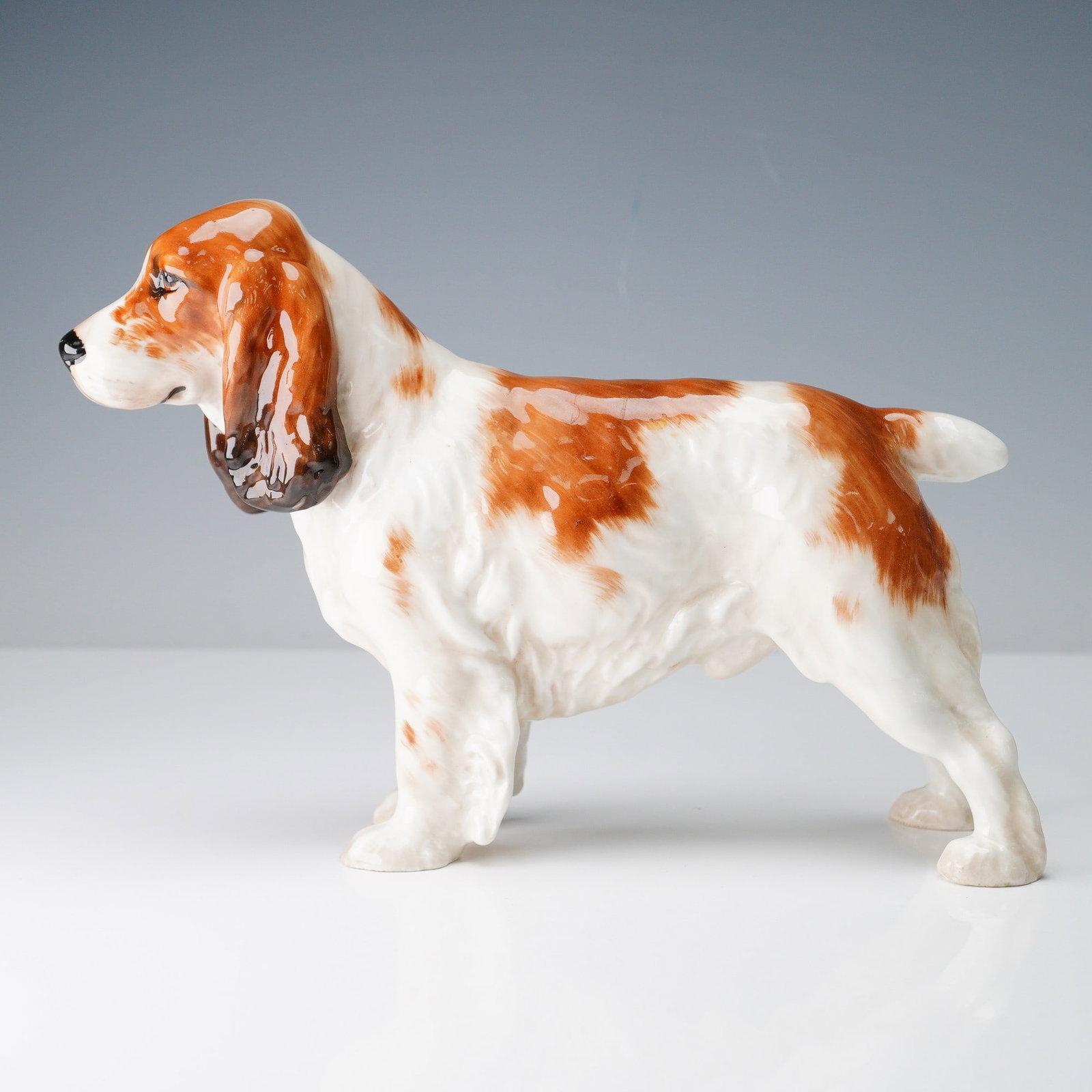 Royal Doulton Dog Figurine, Large Cocker Spaniel HN1002: Beautifully modeled Royal Doulton porcelain figurine of a large Cocker Spaniel, model HN1002, designed by renowned sculptor Frederick Daws. Rendered in hand-painted bone china, this piece captures the