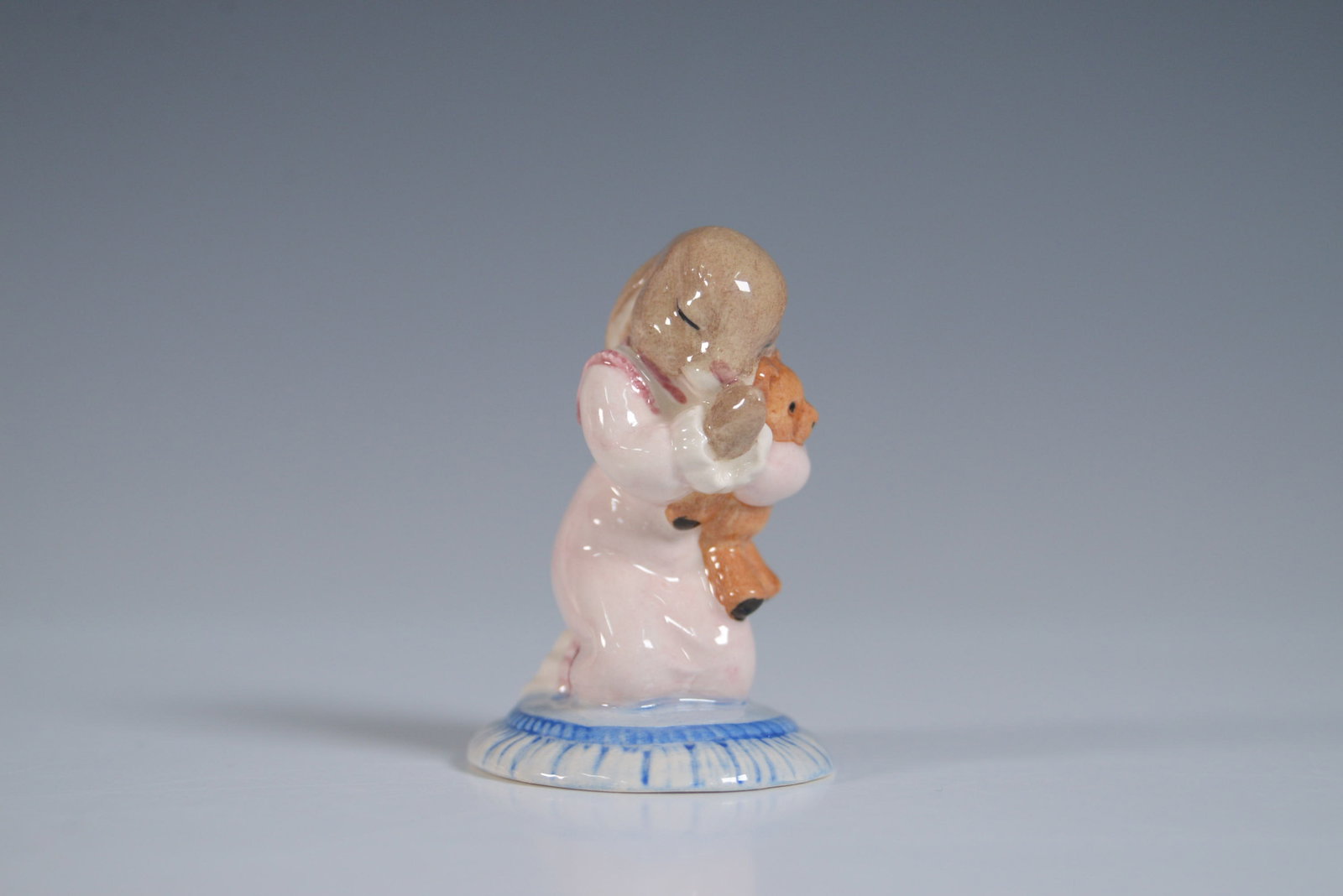 Royal Doulton Bunnykins Figurine Goodnight Bunnykins DB166: Royal Doulton Bunnykins porcelain figurine titled Goodnight DB157 depicting a bunny in pink nightclothes kneeling with a teddy bear. Includes original red and yellow Bunnykins box. Underside shows Roy
