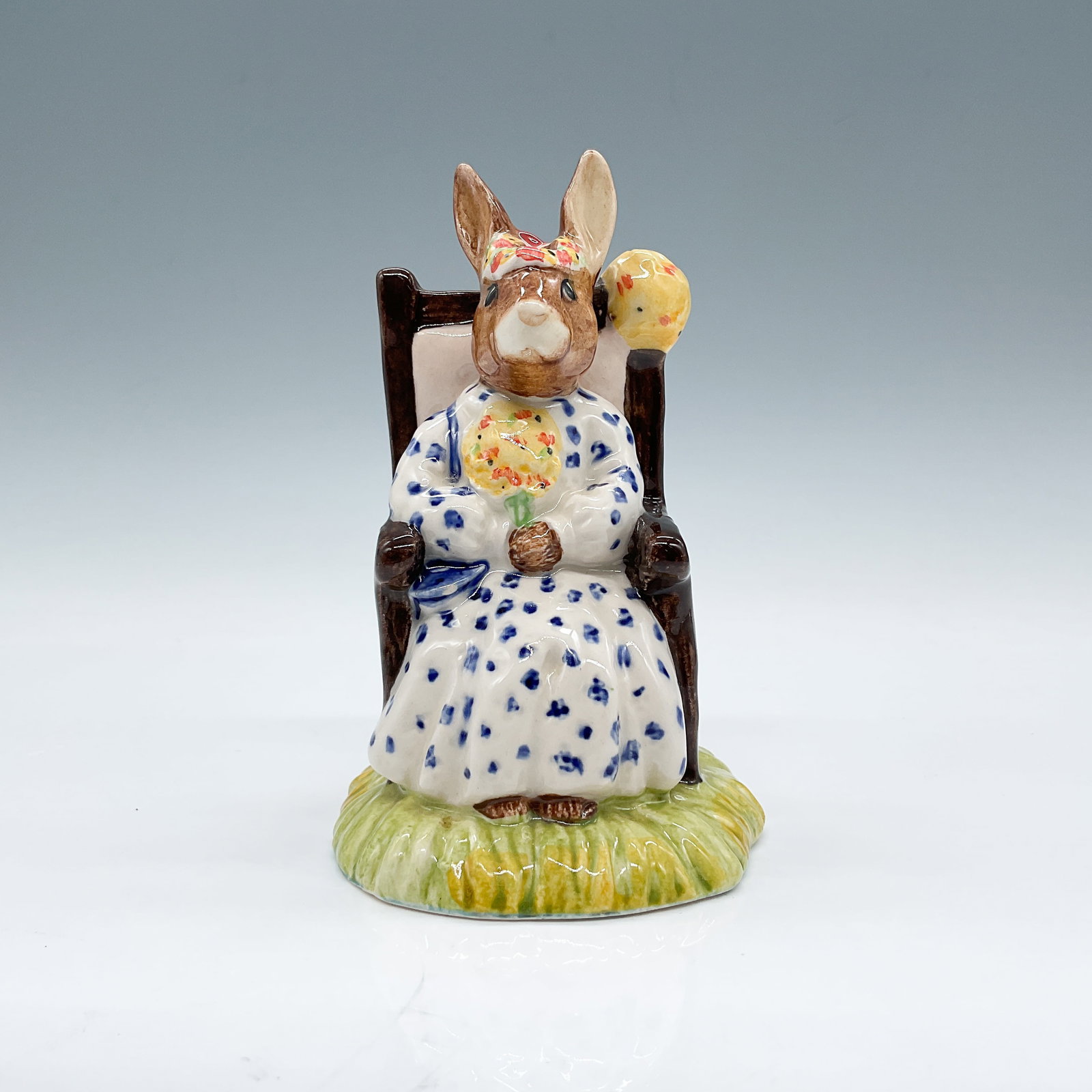 Royal Doulton Bunnykins, Susan Queen of May DB83: Royal Doulton Bunnykins figurine titled "Susan Bunnykins as Queen of the May," model DB83, featuring Susan seated in a chair with floral details on her dress and hat. Marked on the base with the Royal