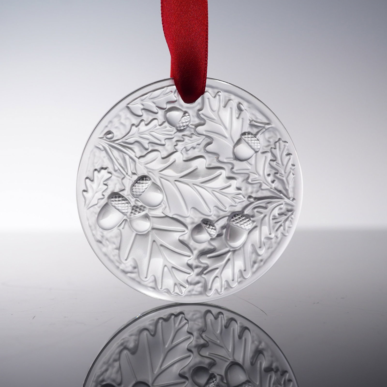 Lalique Frosted Crystal Oak Branch Ornament with Box: A finely molded frosted crystal ornament by Lalique depicting a naturalistic arrangement of oak branches, leaves, and acorns in layered relief. The lifelike composition is enhanced by Lalique's signat