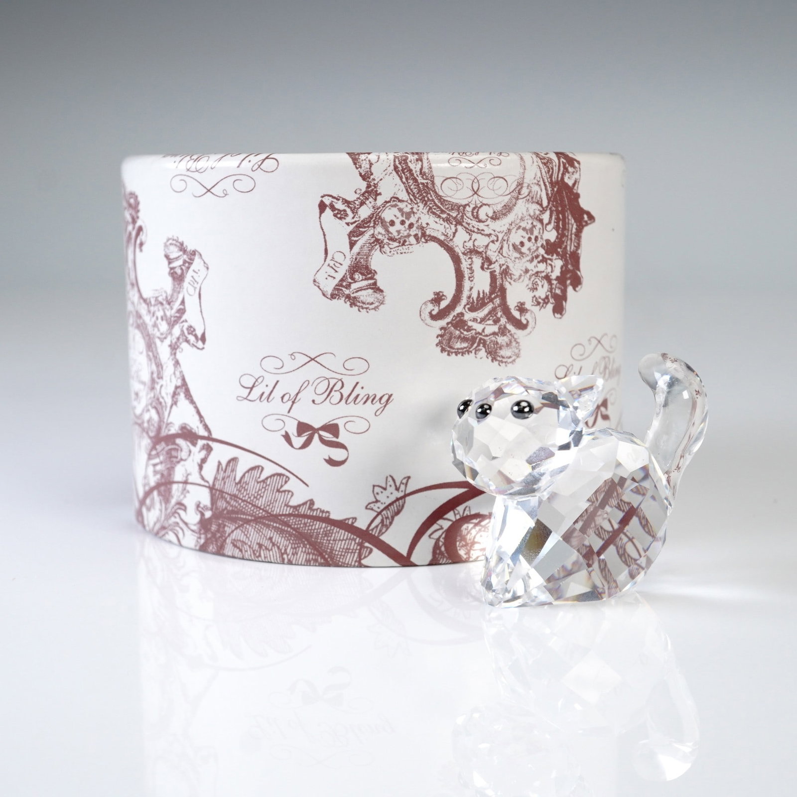 Swarovski Lovlots Pioneers Lil of Bling Cat, 2006 with Box: Sparkling Swarovski crystal figurine Lil of Bling from the Lovlots Pioneers collection, introduced in 2006. Designed by Elke Kumar, this charming cat is crafted in clear faceted crystal with black eye