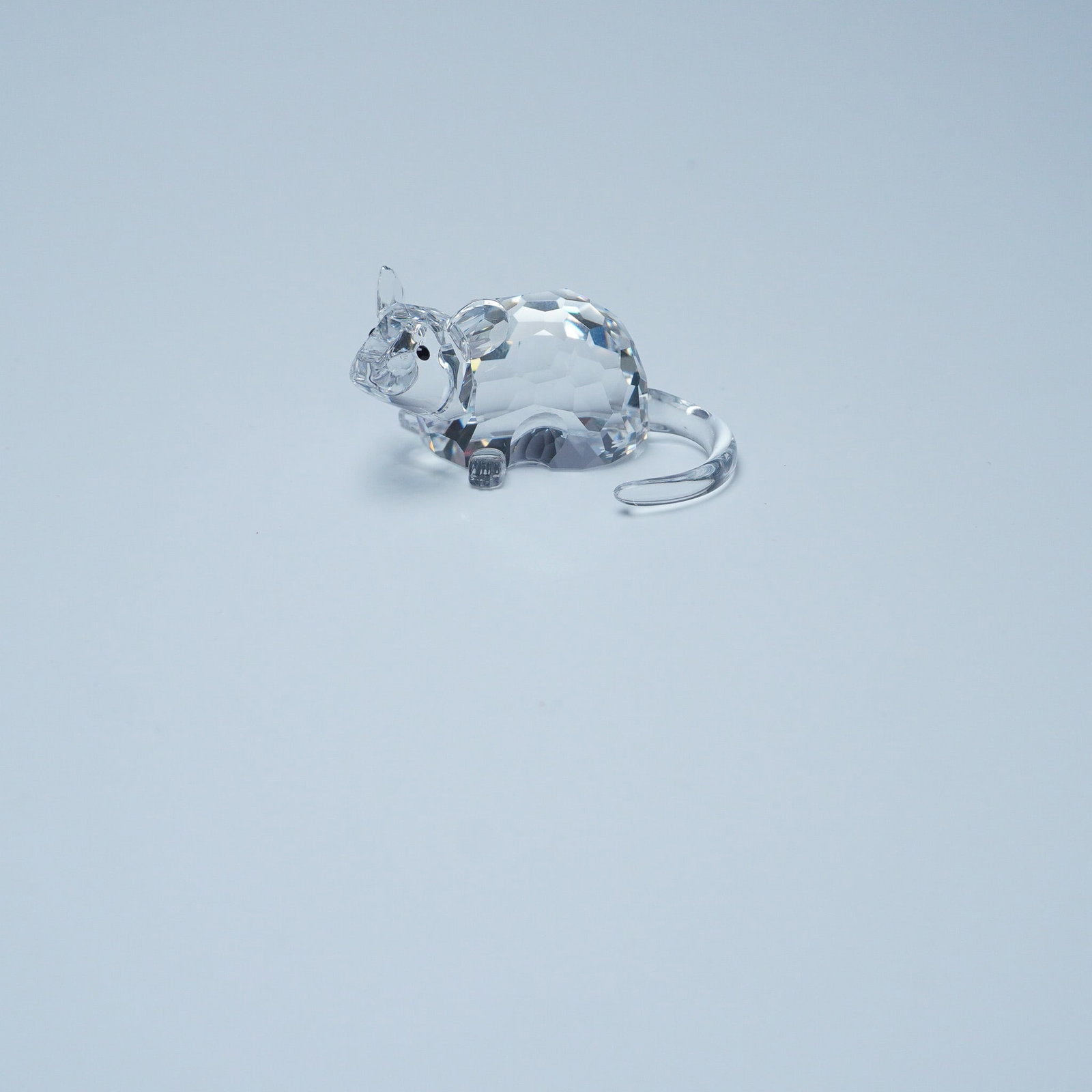 Swarovski Silver Crystal Figurine, Zodiac Rat: This Swarovski Silver Crystal Zodiac Rat figurine is expertly crafted from clear precision-cut crystal, featuring a faceted body, delicate ears, and a curved tail that symbolizes cleverness and resour