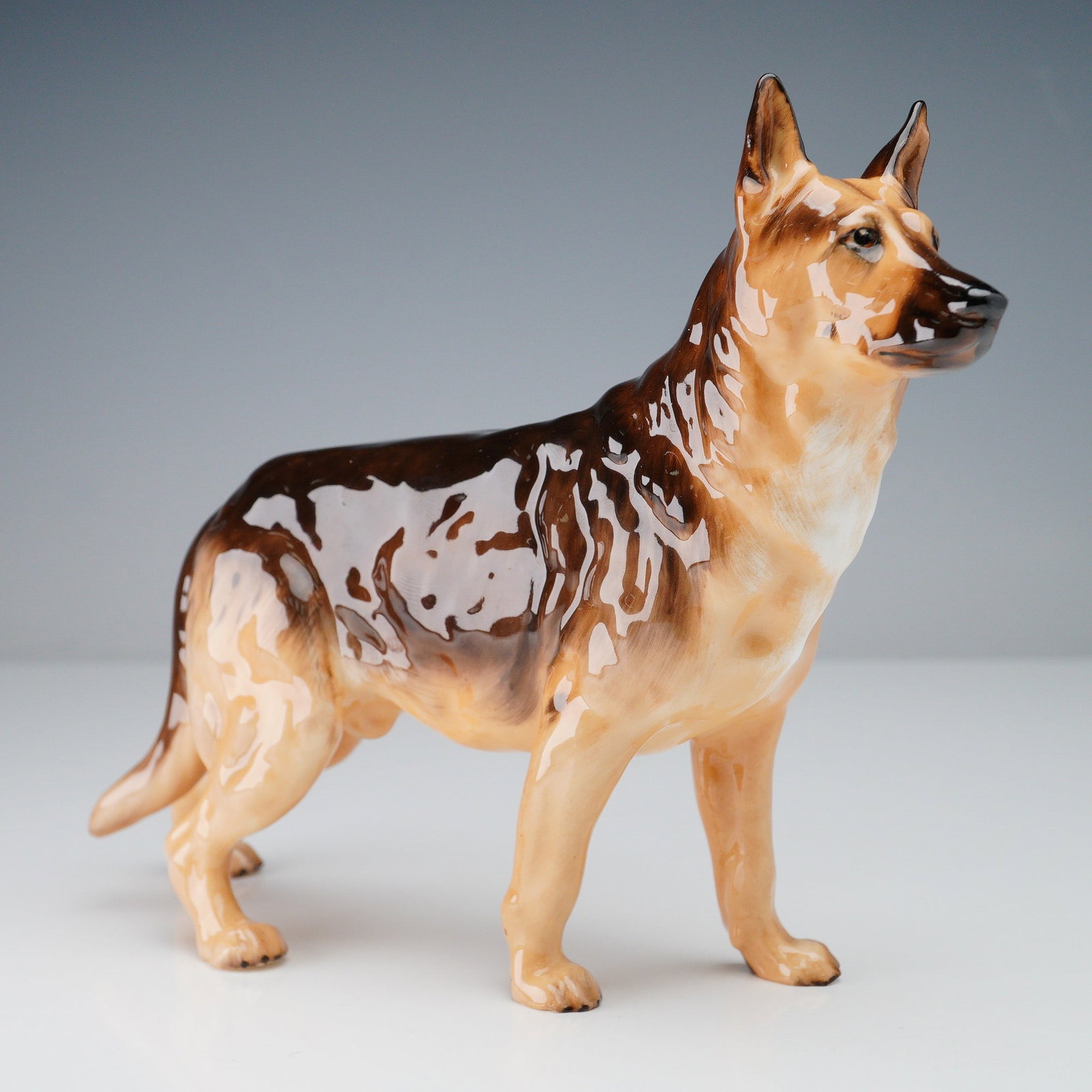 Royal Doulton Porcelain Figurine, Alsatian HN1116: Produced by Royal Doulton, this bone china figurine features an alert and noble Alsatian (German Shepherd), skillfully rendered with a lifelike pose and detailed hand-painted glaze. This model, HN1116