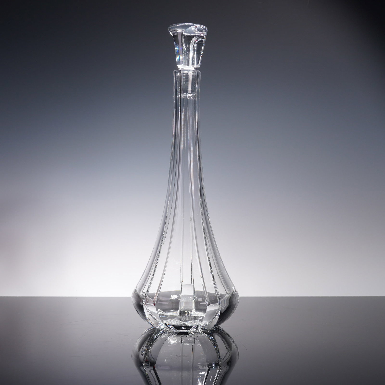 Baccarat Crystal Decanter, Neptune with Stopper and Box: An elegant Baccarat crystal decanter featuring a slender, fluted silhouette with graceful curves and matching faceted stopper. Etched with the Baccarat hallmark on the base and accompanied by the orig