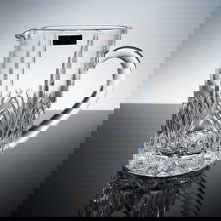 Marquis by Waterford Crystal Brookside Pitcher with Box: This 7-inch Brookside pitcher by Marquis by Waterford features a sleek cylindrical shape adorned with precise vertical cuts and a dramatic crisscross motif near the base. Crafted from fine lead crysta
