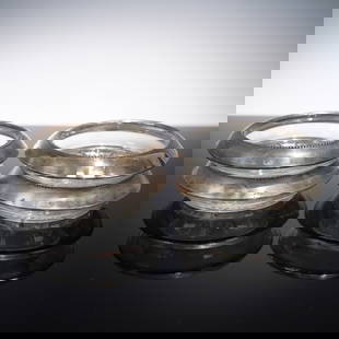 4pc Frank M. Whiting Sterling Silver and Glass Coasters: This elegant set of four vintage coasters combines the refined beauty of cut glass with the timeless appeal of sterling silver. Crafted by Frank M. Whiting & Co., each coaster features a sterling silv