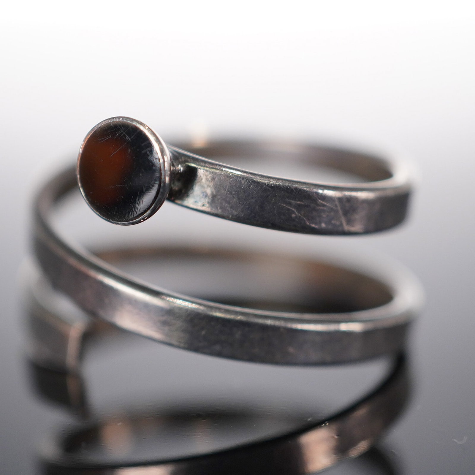 Sterling Silver Snake Ring w/Black Onyx Bezel, Size 10: Unique design of sterling silver designed into a coil. End tip is accented with black onyx bezel. Impressed mark 925 Mexico. Total weight 6g. Issued: 20th century Dimensions: See Description Country o