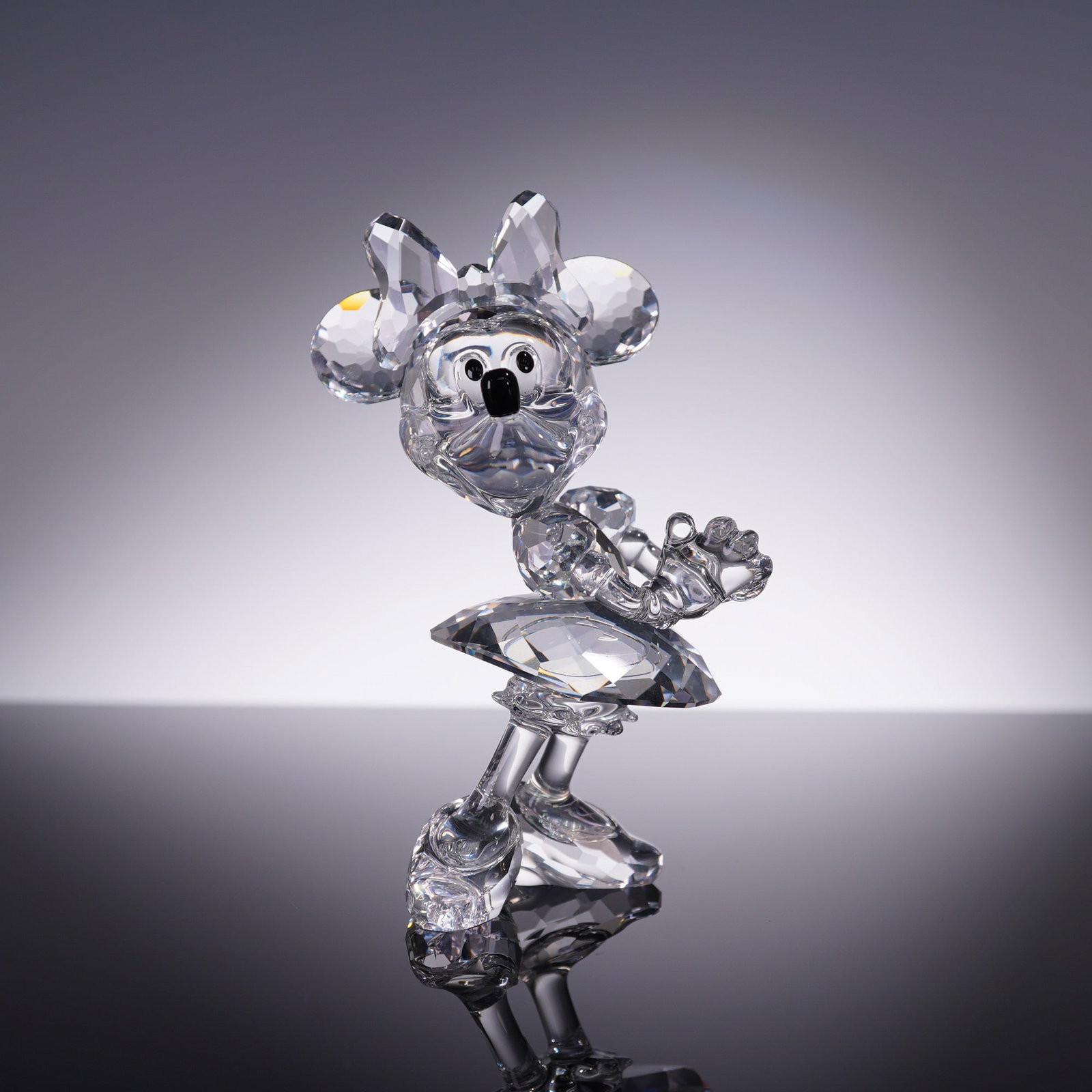 Swarovski Crystal Figurine, Disney Minnie Mouse 687436: From the Swarovski Disney Showcase Collection, this clear faceted crystal figurine of Minnie Mouse model 687436 features her iconic bow, skirt, and cheerful pose. Etched with DISNEY and Swarovski swan