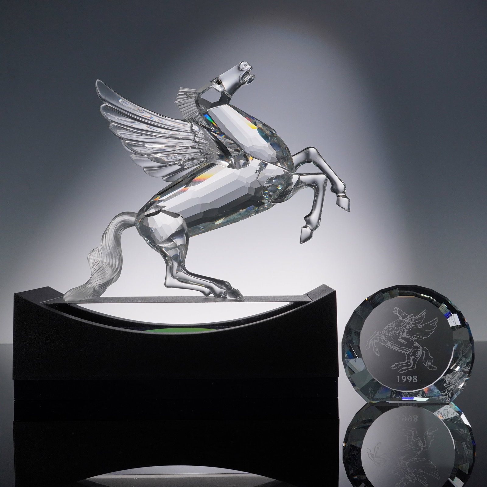 3pc Swarovski Crystal Pegasus Figurine with Plaque & Display: 1998 Swarovski crystal figurine of Pegasus issued for the SCS as the final piece in the Fabulous Creatures trilogy. The rearing winged horse is crafted with a fully faceted body and wings that reflect