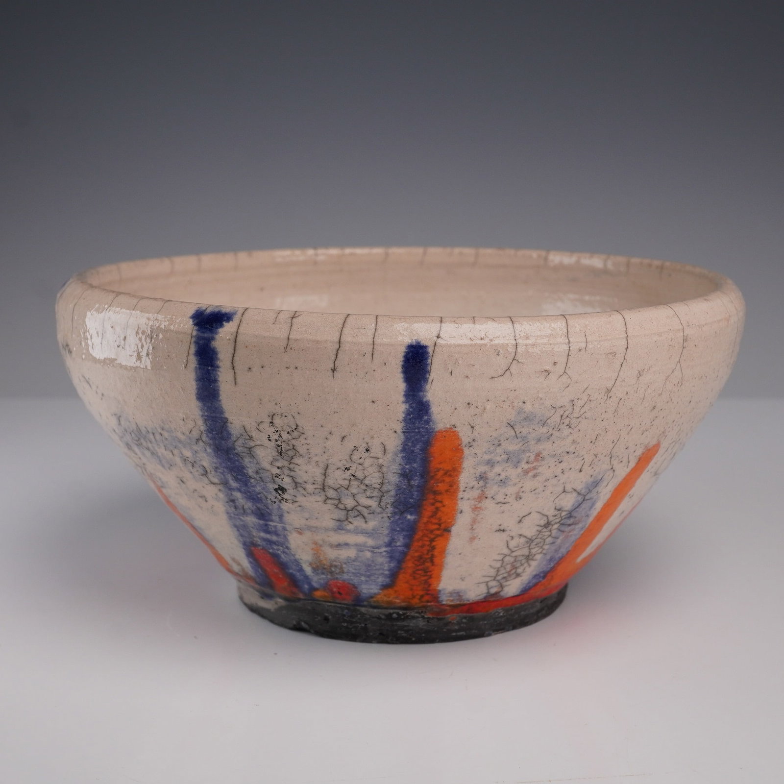 Studio Raku Pottery Bowl, Abstract Drip Decoration, Signed: A dynamic hand-thrown raku-fired studio pottery bowl, signed and dated '81 to the base. The form features a flared profile and slightly raised foot, measuring approximately 3.5 inches high and 7 inche
