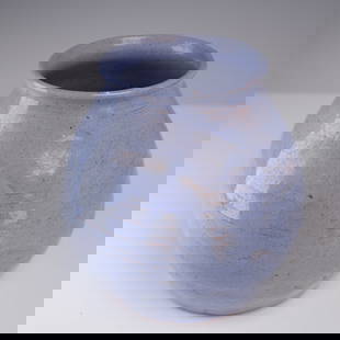 Studio Pottery Vase With Blue Crackle Glaze: Hand-thrown studio pottery vase with a rounded bulbous body and flared rim, finished in a soft lavender-blue crackle glaze. The surface displays subtle horizontal turning marks from the wheel and inte