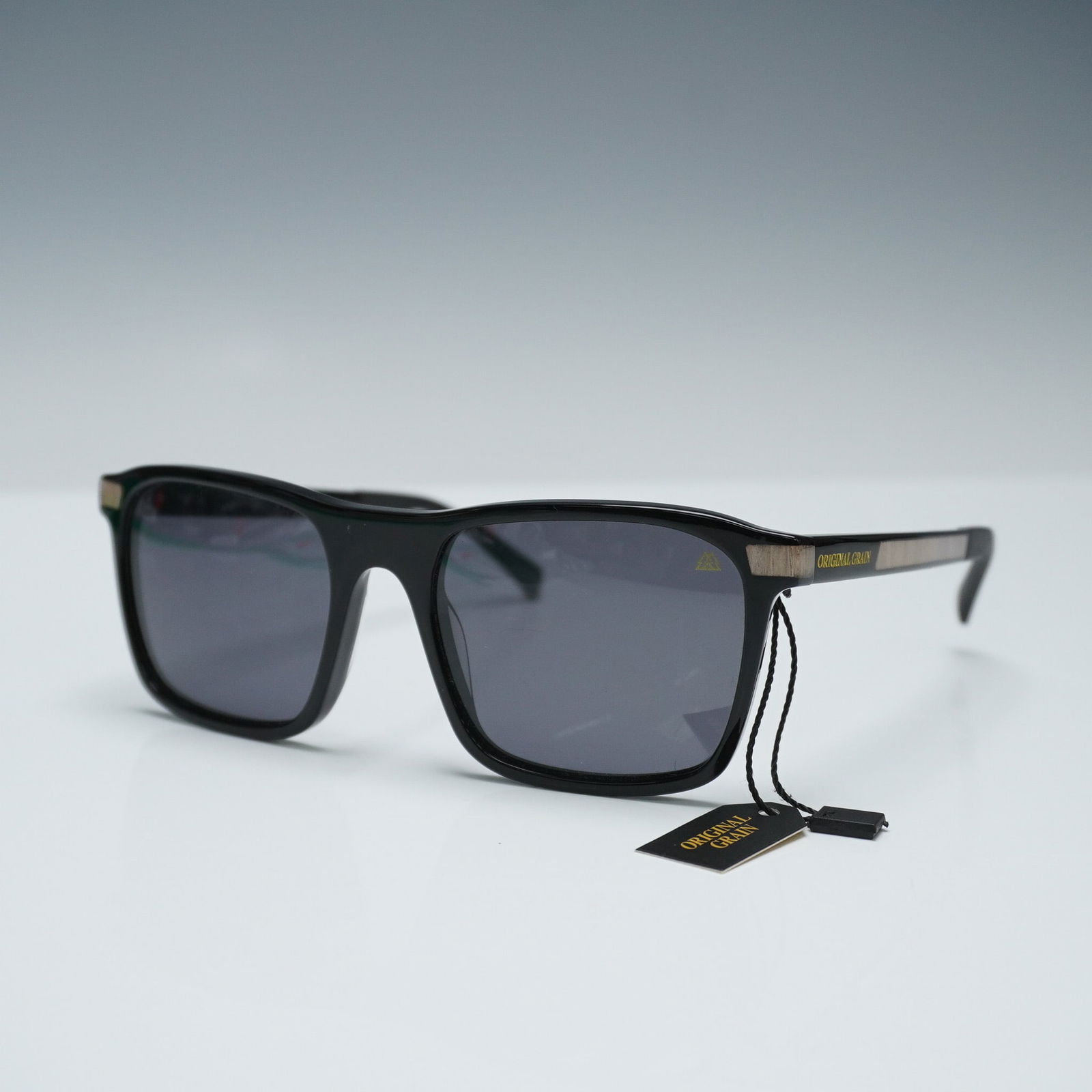 Original Grain Ridgeline Sunglasses, Polarized 145: Original Grain Ridgeline sunglasses featuring a classic black frame with natural wood inlays at the temple arms, blending traditional style with modern craftsmanship. This polarized model offers glare