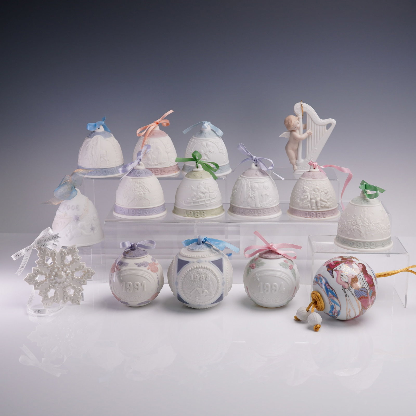 15pc Lladro Porcelain Christmas Ornament Collection: This lot features a stunning collection of 15 authentic Lladro porcelain Christmas ornaments spanning nearly two decades, from 1987 to 2006. Included are ten annual bell ornaments: 1987 with a nativit