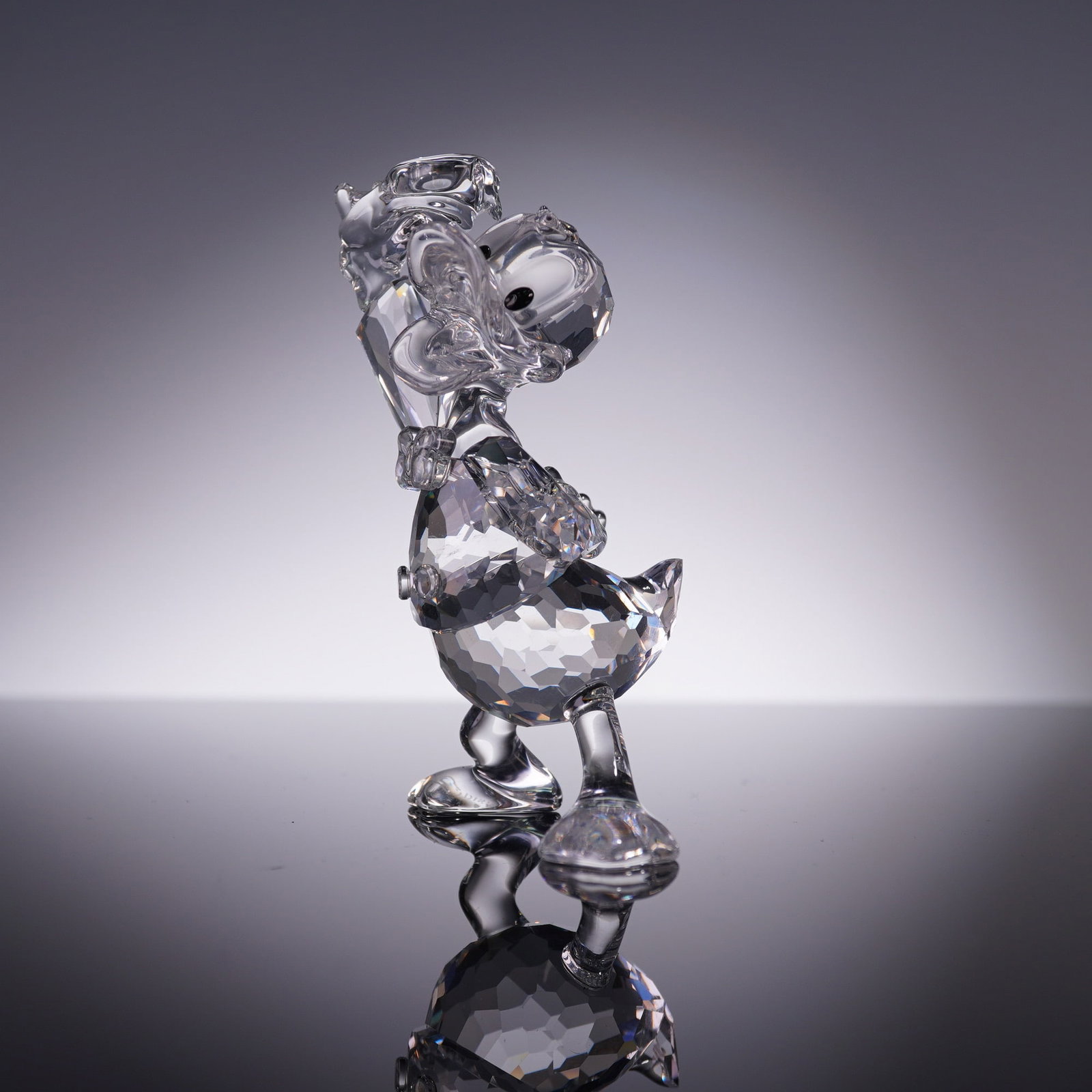 Swarovski Crystal Figurine, Disney Donald Duck 687339: From the Swarovski Disney Showcase Collection, this faceted crystal figurine of Donald Duck model 687339 captures his classic animated charm in clear precision-cut crystal. Features etched DISNEY and 