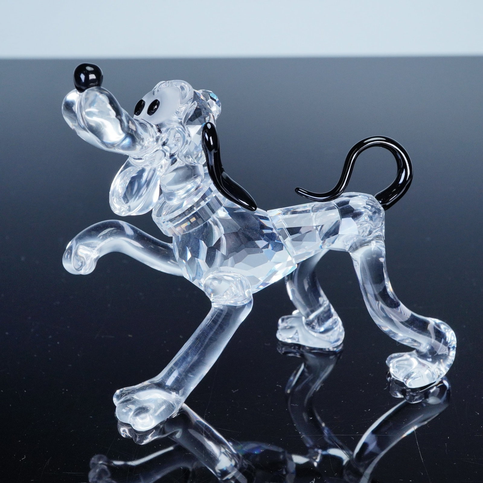 Swarovski Crystal Figurine, Disney Pluto 692344: From the Swarovski Disney Showcase Collection, this faceted crystal figurine of Pluto model 692344 captures Mickey's loyal companion with black crystal accents on the ears, tail, and nose. Etched with