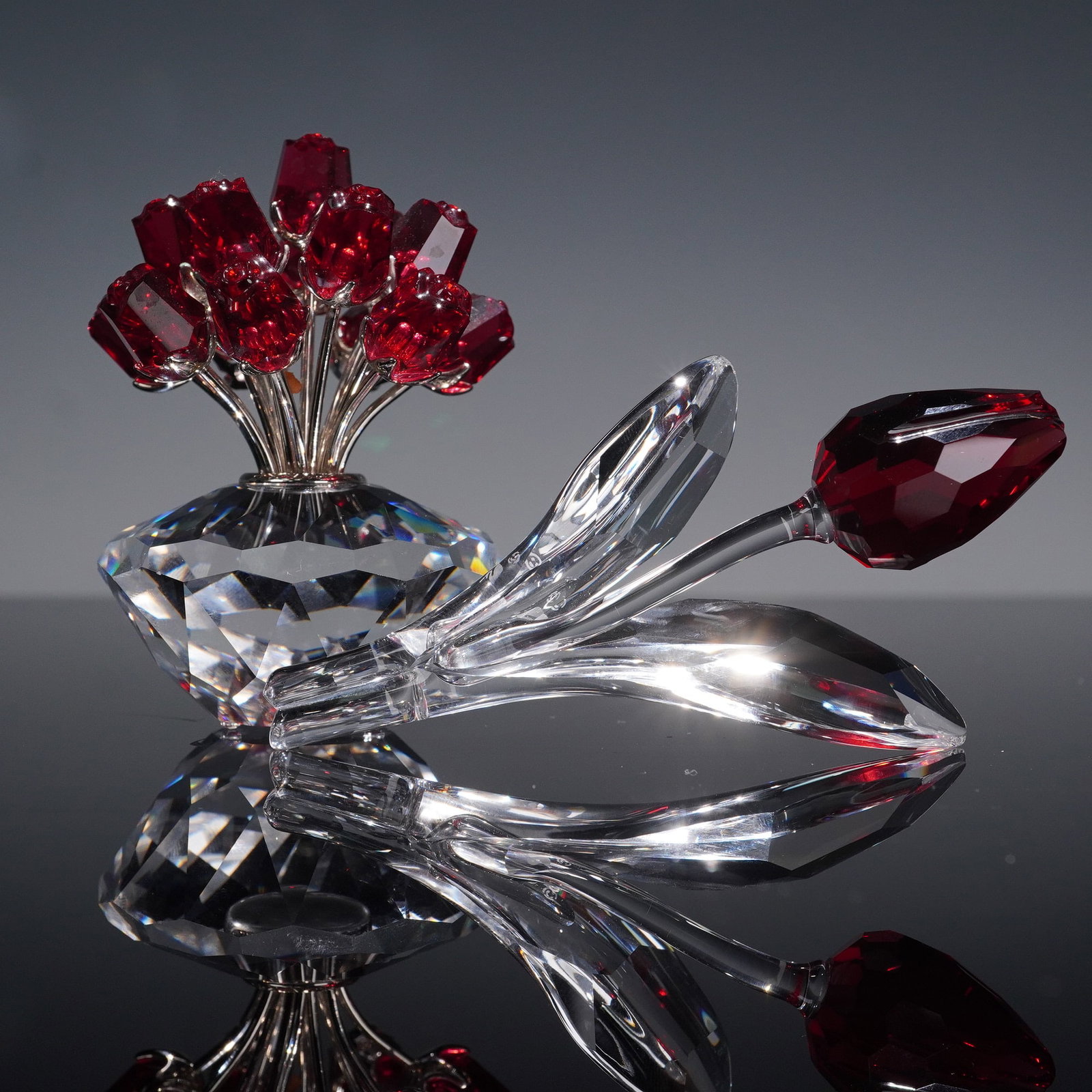 2pc Swarovski Crystal Figurines, Red Flowers: This listing features a stunning Swarovski SCS "Magic of Crystal" limited edition set, showcasing two exquisite floral crystal sculptures that exemplify the brand's renowned craftsmanship and elegance