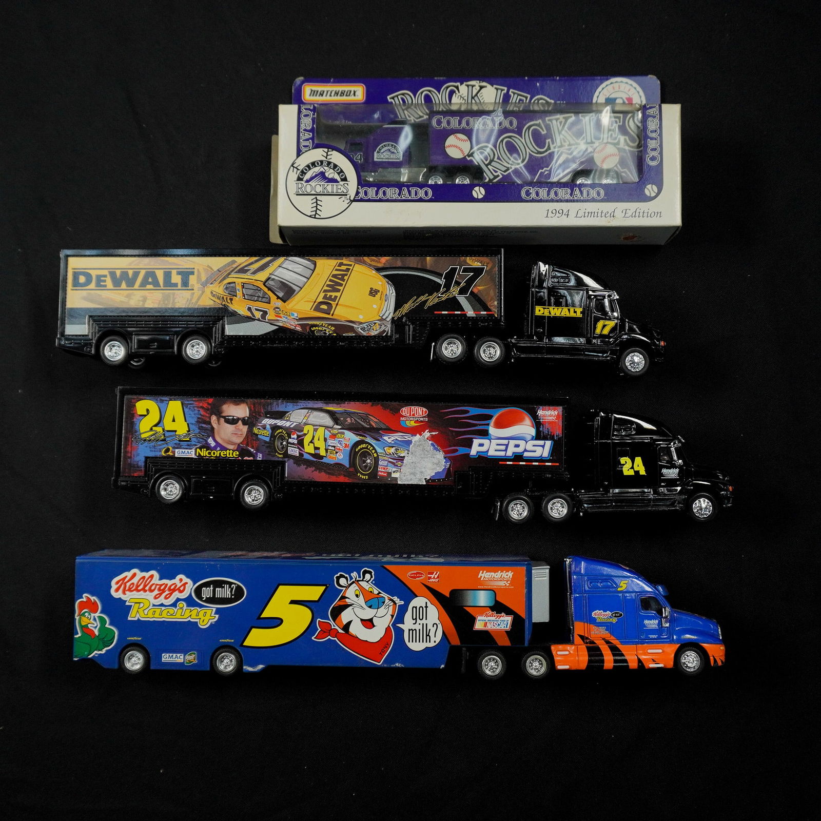4pc Die Cast Baseball and NASCAR Toy Truck Haulers: A collection of four die cast collectible trucks including a 1994 limited edition Matchbox Colorado Rockies truck in original packaging, 3 NASCAR themed haulers by Motorsports Authentics. The NASCAR t