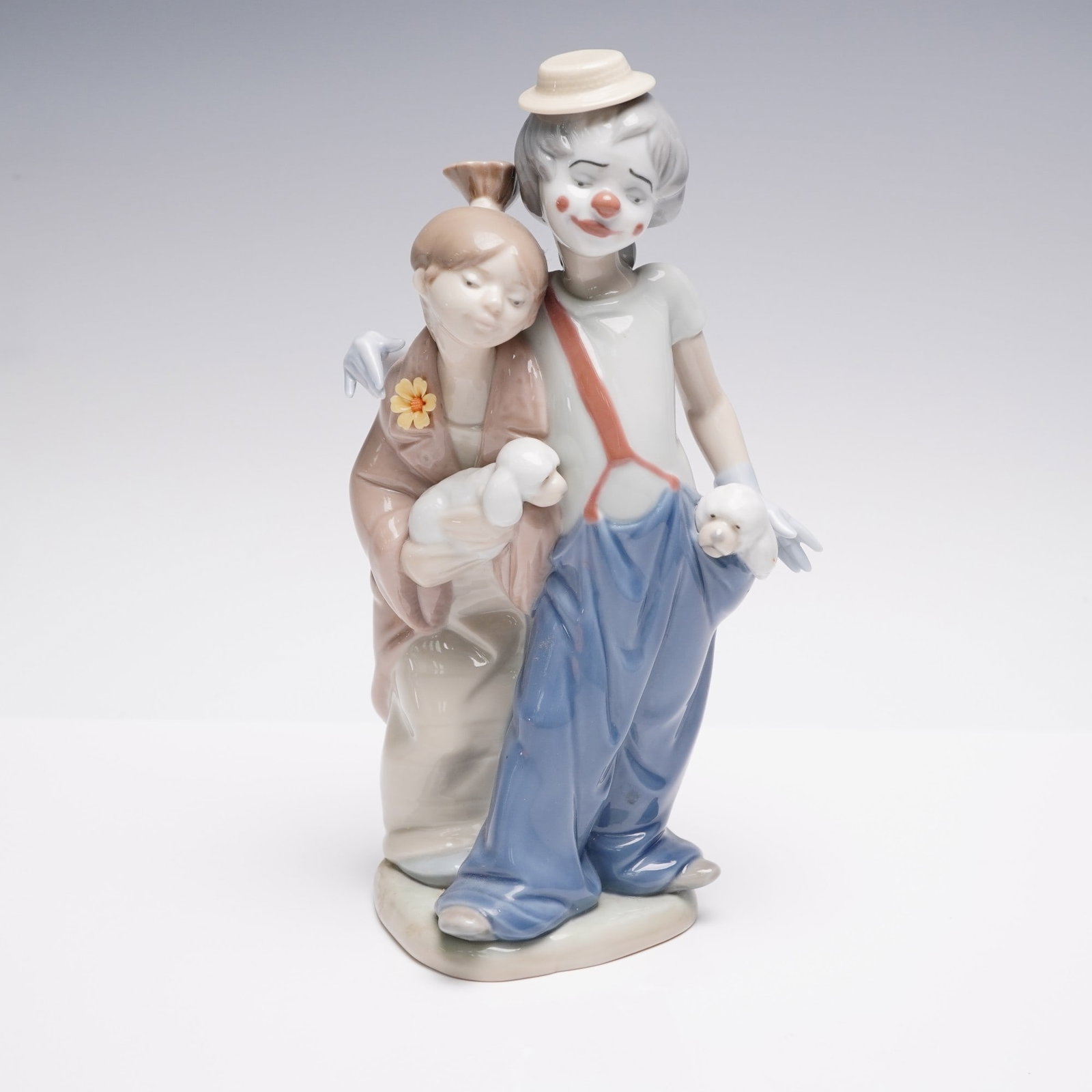 Lladro Porcelain Figurine, Pals Forever 1007686: Lladro porcelain figurine titled "Pals Forever" model 1007686, sculpted by Juan Huerta. Issued in 2000 as part of the Lladro Collectors Society, this touching piece features a clown and a young girl w