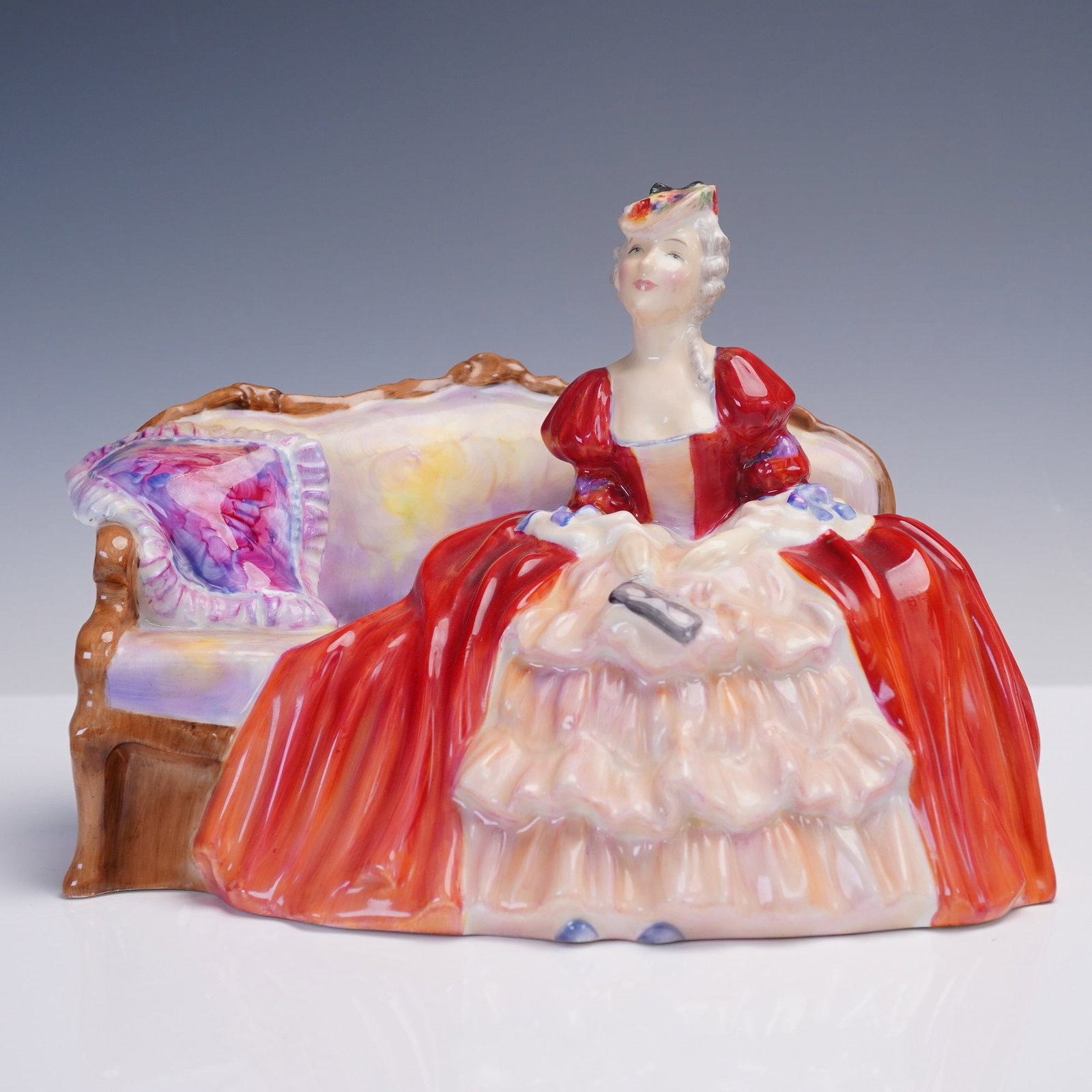 Royal Doulton Figurine, Belle o' the Ball HN1997: Graceful Royal Doulton porcelain figurine titled Belle o' the Ball, HN1997. Designed by R. Asplin and first issued in 1947, this figure remained in production until 1979. It depicts a refined lady sea