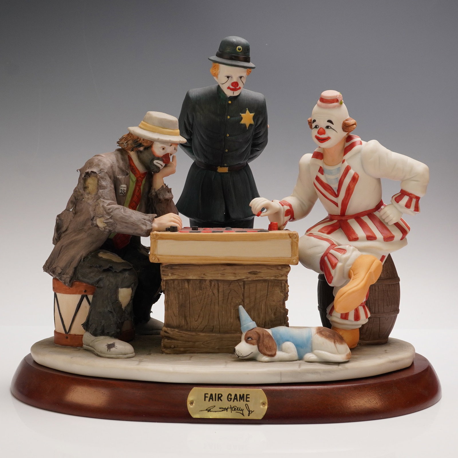 Flambro Emmett Kelly Jr. Figurine, Fair Game: This charming limited edition figurine titled Fair Game captures the whimsical essence of Emmett Kelly Jr.'s iconic clown persona as he plays a game of checkers against another clown while a third clo