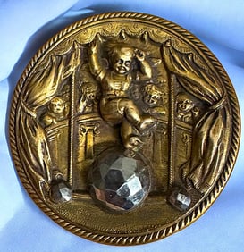 A brass and steel pictorial button