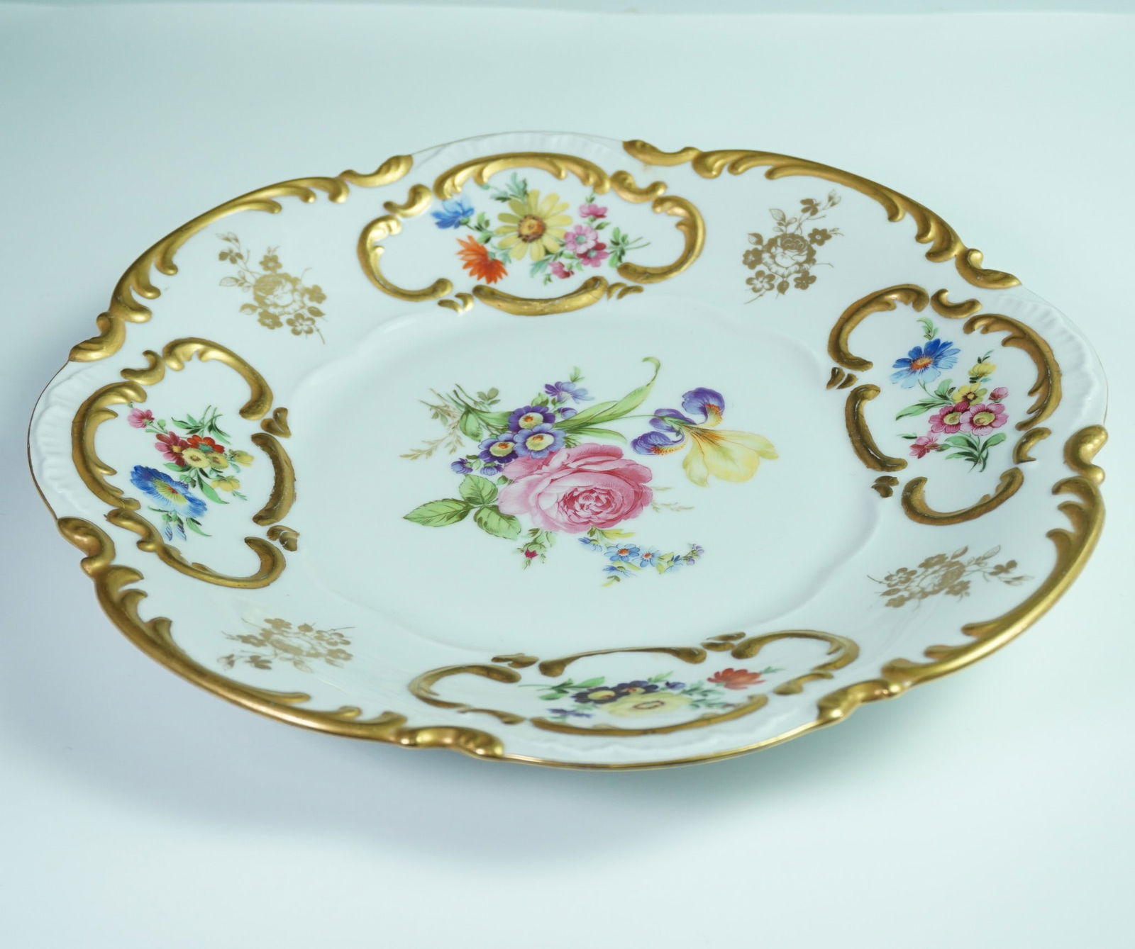 Lorenz Hutschenreuther Germany Porcelain Floral and Gilt Porcelain Plate: Decorative porcelain plate by Lorenz Hutschenreuther, Germany, featuring a richly detailed central floral bouquet surrounded by alternating cartouches of hand-painted flowers and gold floral transfers
