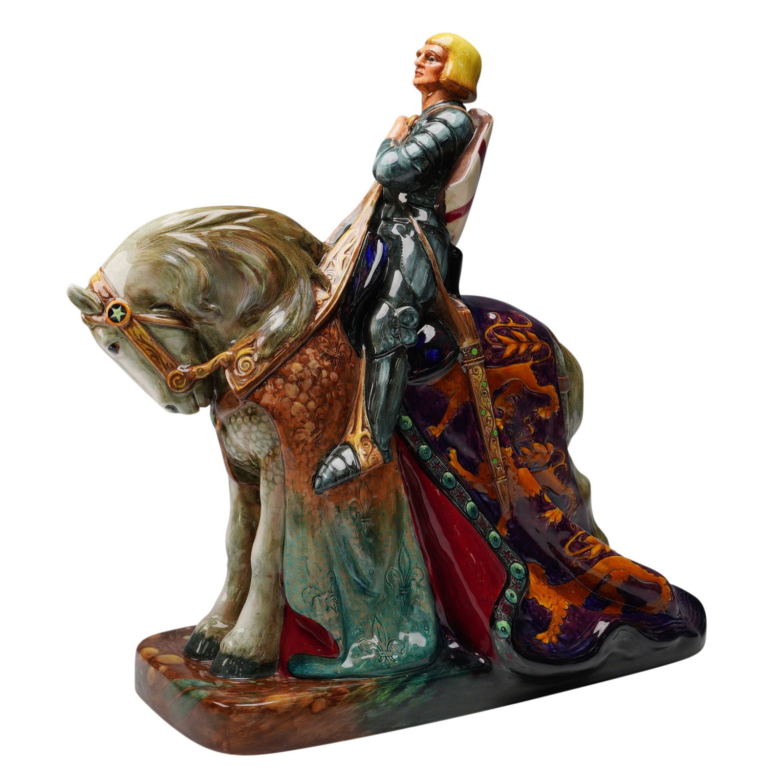 Royal Doulton Figurine, St. George HN2067: Glazed ceramic figurine by Royal Doulton depicting St. George in full armor seated atop a caparisoned horse. St. George is shown holding a sword across his right side, dressed in a detailed suit of ma