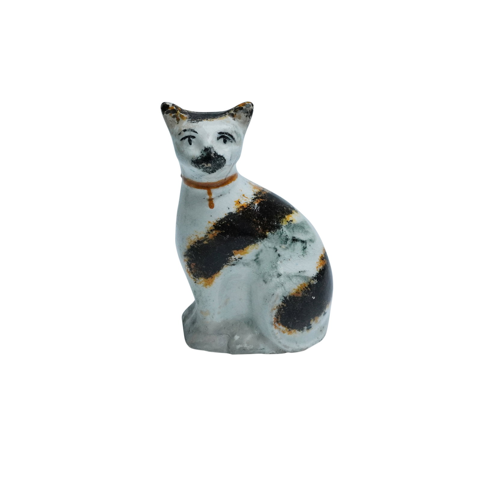 Staffordshire Pottery Seated Cat Figurine: This delightful Staffordshire pottery cat figurine dates to around 1850, showcasing the typical craftsmanship of the era. The piece features a hand-painted cat with distinct black and orange markings 