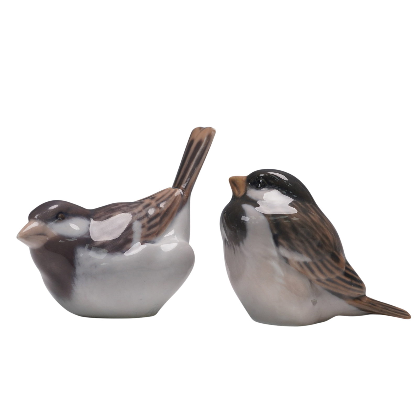 2pc Royal Copenhagen Porcelain Figurines, Sparrow #1519 & Chickadee #1081: Charming pair of hand-painted porcelain bird figurines by Royal Copenhagen, Denmark. This lot includes Sparrow model #1519 and Chickadee model #1081, both rendered in finely shaded tones of brown, gre