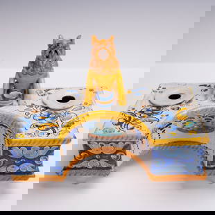 Spanish Talavera Faience Polychrome Lion-Form Double Inkwell Desk Set: A remarkable example of Spanish ceramic artistry, this exuberant Talavera faience double inkwell is both functional and whimsical. At its center sits a boldly modeled seated lion in bright golden ochr