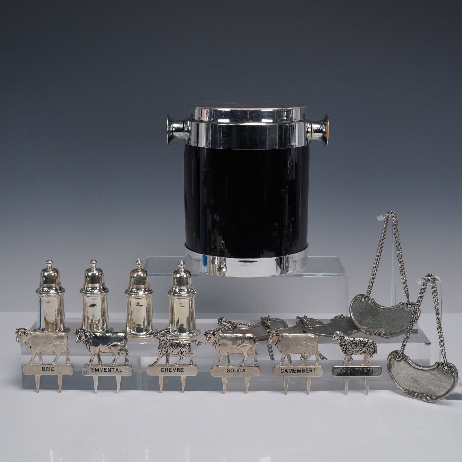 15pc Dinnerware Entertainment Set: This group features six silver tone cheese markers for Brie, Emmental, Chevre, Gouda, Camembert, and Roquefort, each adorned with charming animal figures. Also included are five Arte Italica wine bott