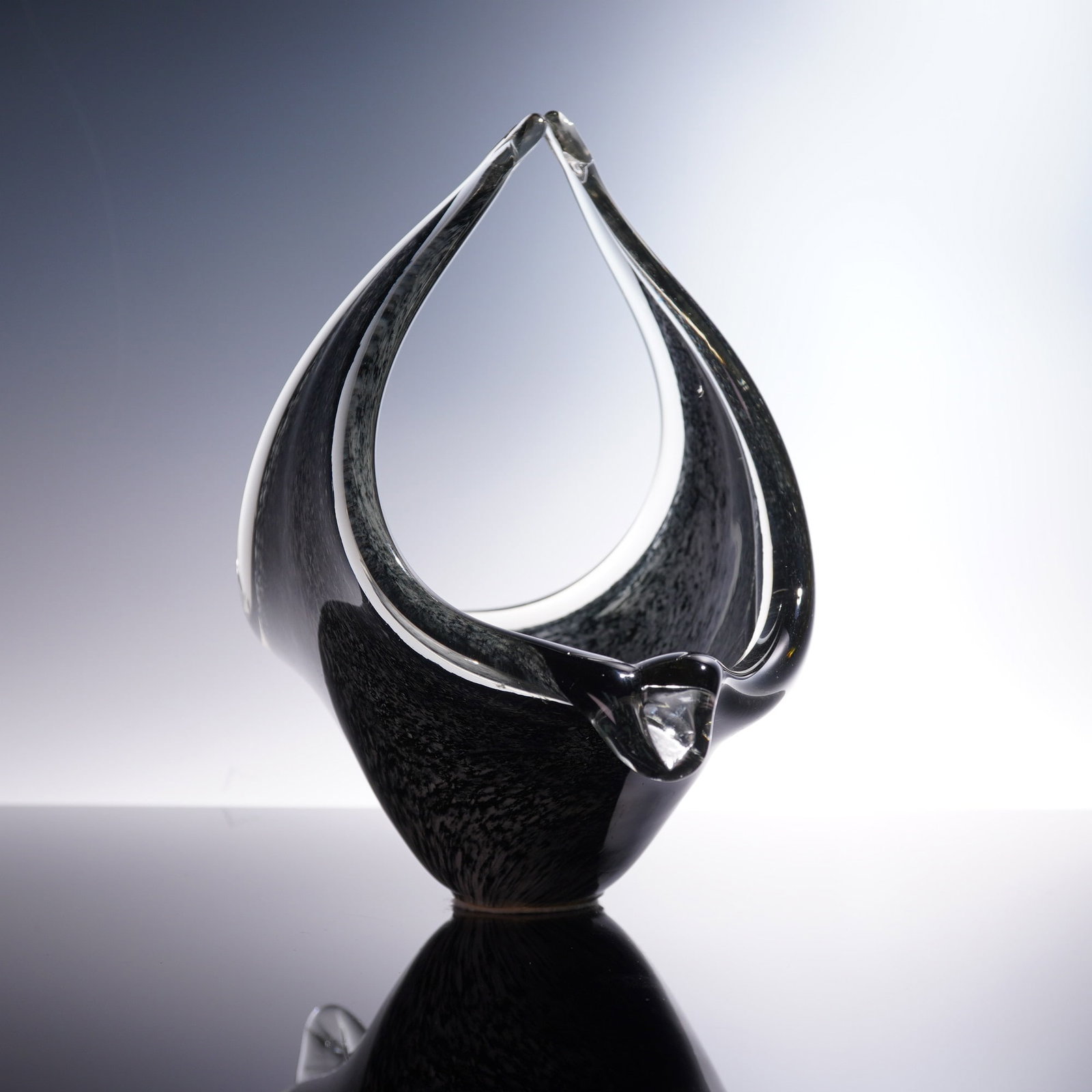 Murano Sculptural Art Glass Teardrop Centerpiece Bowl: Murano art glass centerpiece bowl in a striking open-form design with teardrop profile and upward-flaring points. The smoky black interior is encased in clear glass with heavy walls and smoothly polis