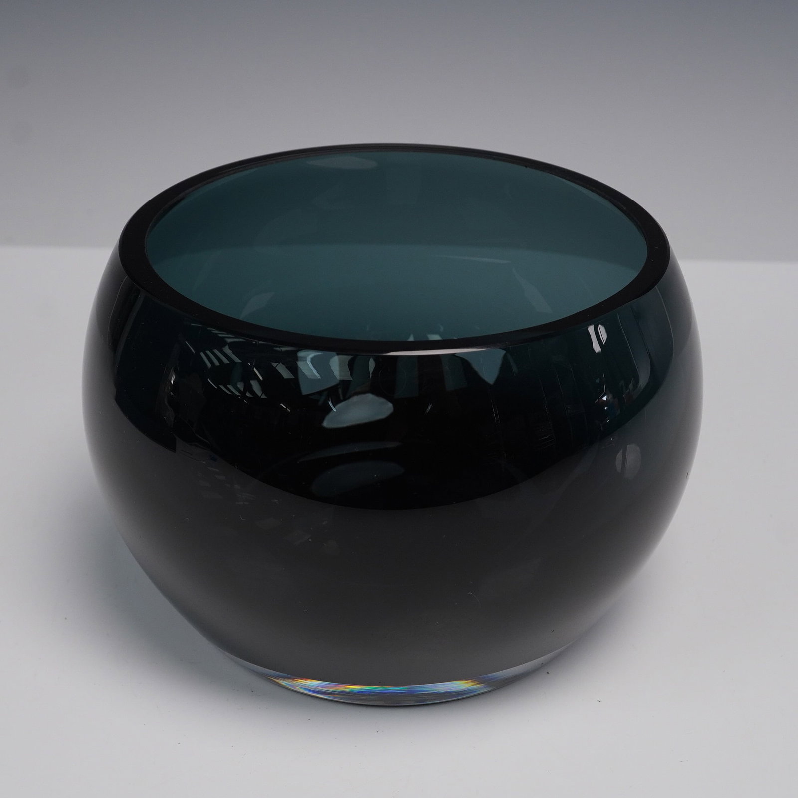 Georg Jensen Cafu Glass Bowl with Box: Sleek modernist glass bowl for Georg Jensen's Cafu Collection. Freeform rounded silhouette in deep teal blue, with polished rim and flat base. Signed on underside Georg Jensen Denmark. Includes origin
