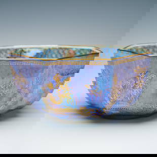 Wedgwood Fairyland Lustre Octagon Dragon Motif Bowl: The exterior is coated in a blue lustre glaze with a mottled and streaked appearance, accented by areas of pale staining. Decorative elements feature gilded representations of Asian-style dragons and