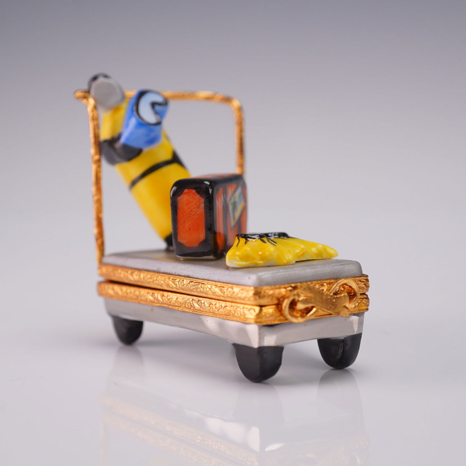 Limoges France Ring Box with Scuba Gear Luggage Design: Chateau Limoges hand painted porcelain ring box featuring a whimsical scuba diving theme, with miniature luggage, flippers, and an air tank on a bellman's cart. The interior is decorated with a floral