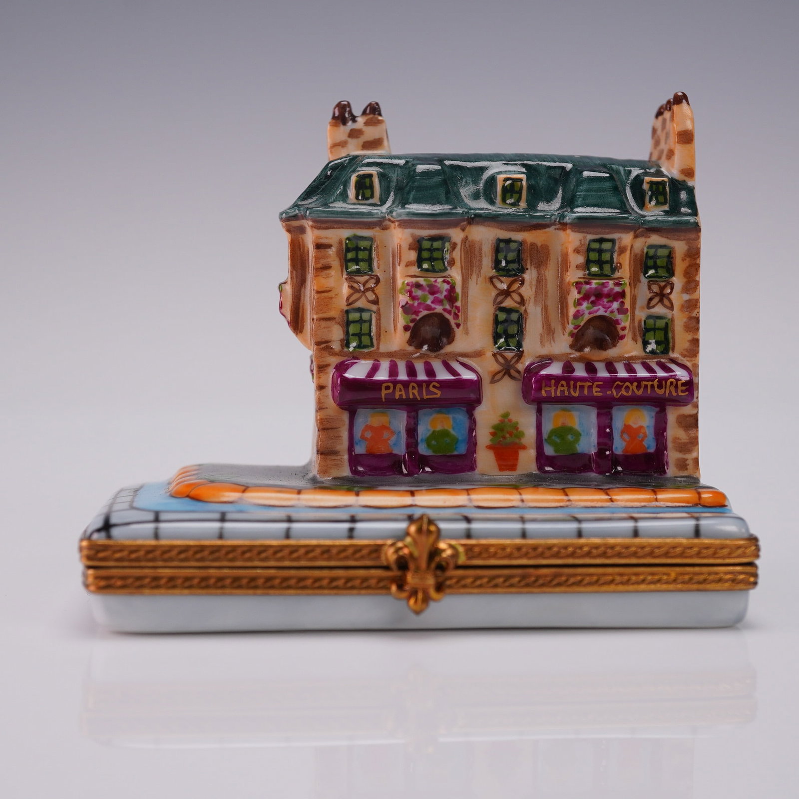 Rochard Limoges Paris Haute Couture Boutique Ring Box: Charming hand-painted porcelain box by Rochard Limoges France styled as a Parisian haute couture boutique with Paris and Haute Couture signage flower boxes and painted storefront detail. The hinged li
