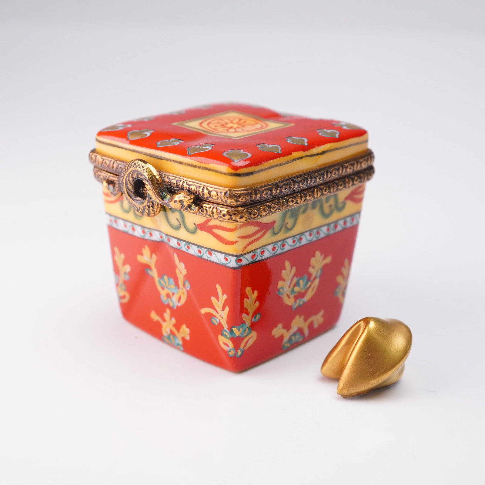 Rochard Limoges Hand Painted Porcelain Box - Chinese Takeout Box Form: A finely hand painted Limoges porcelain trinket box by Rochard, France, modeled in the form of a Chinese takeout box. Decorated with bright red, gold, and teal floral motifs with an intricate ouroboro