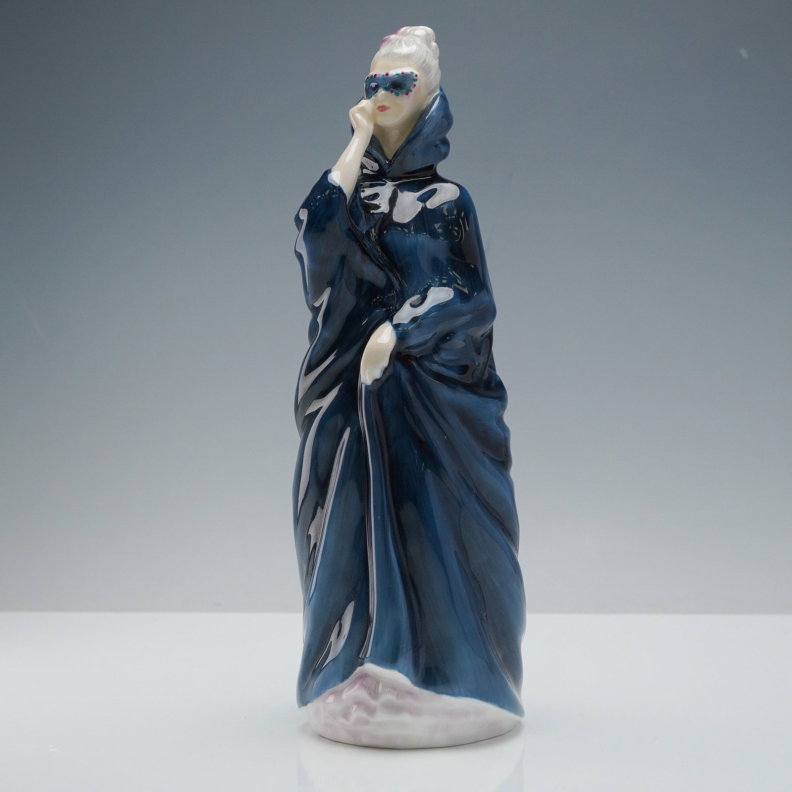 Royal Doulton Figurine, Masque HN2254: Royal Doulton figurine titled Masque, model HN2254. Designed by Douglas V. Tootle, this elegant piece was issued in 1961 and is part of the iconic HN series, known for its graceful depictions of women
