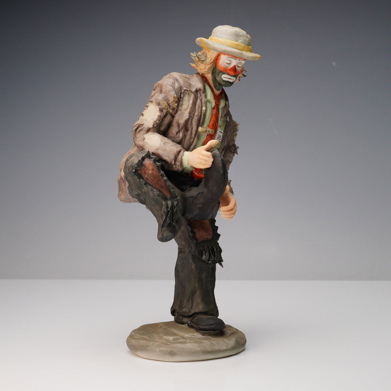 Flambro Emmett Kelly Jr. Porcelain Figurine: Hand-painted bisque porcelain figurine from the Emmett Kelly Jr. Signature Collection, produced exclusively by Flambro Imports in Taiwan. This meticulously crafted figurine features the iconic charact