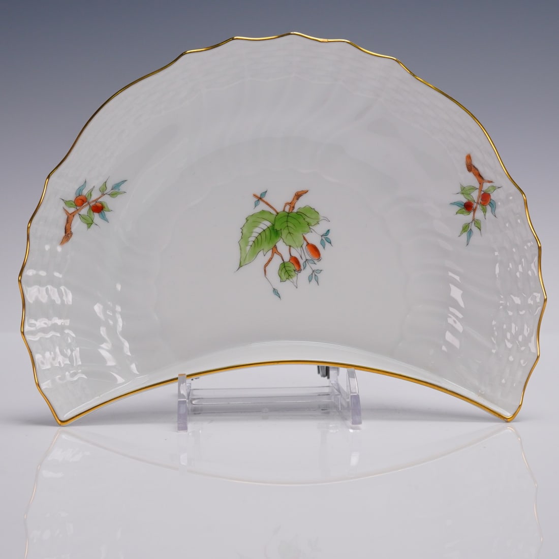 Herend Porcelain HER16 Moon Plate with Fruit Branch: Herend porcelain crescent-shaped side plate in the HER16 pattern, featuring hand-painted branches with orange fruit and leaves, finished with a gold-rimmed scalloped edge. Marked with the Herend Hunga