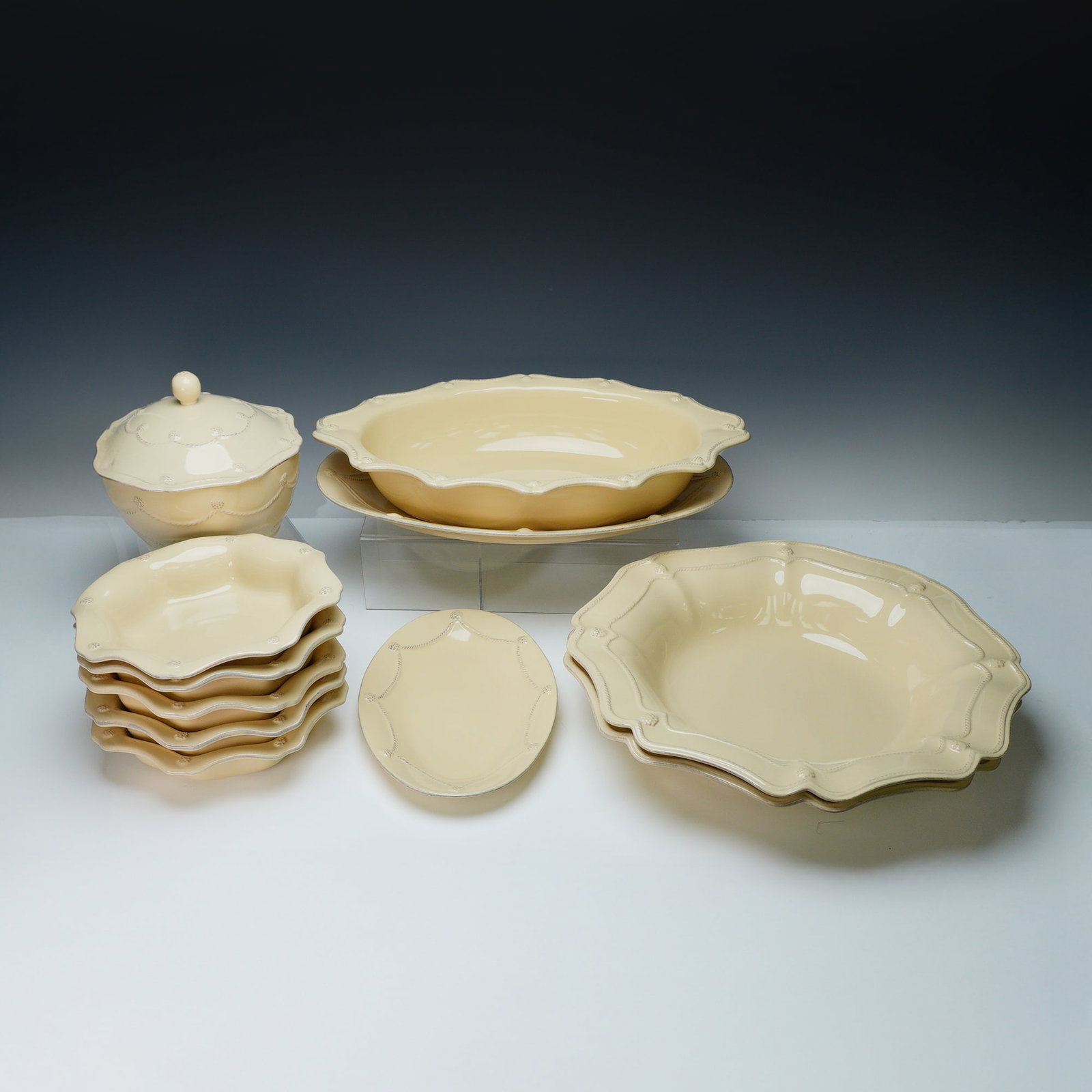 11pc Juliska Stoneware Berry & Thread Platters & Bowls: A charming 11-piece collection of Juliska stoneware serving pieces in the beloved "Berry & Thread" pattern. Rendered in a creamy white glaze, each piece features the signature scalloped edge, thread-l