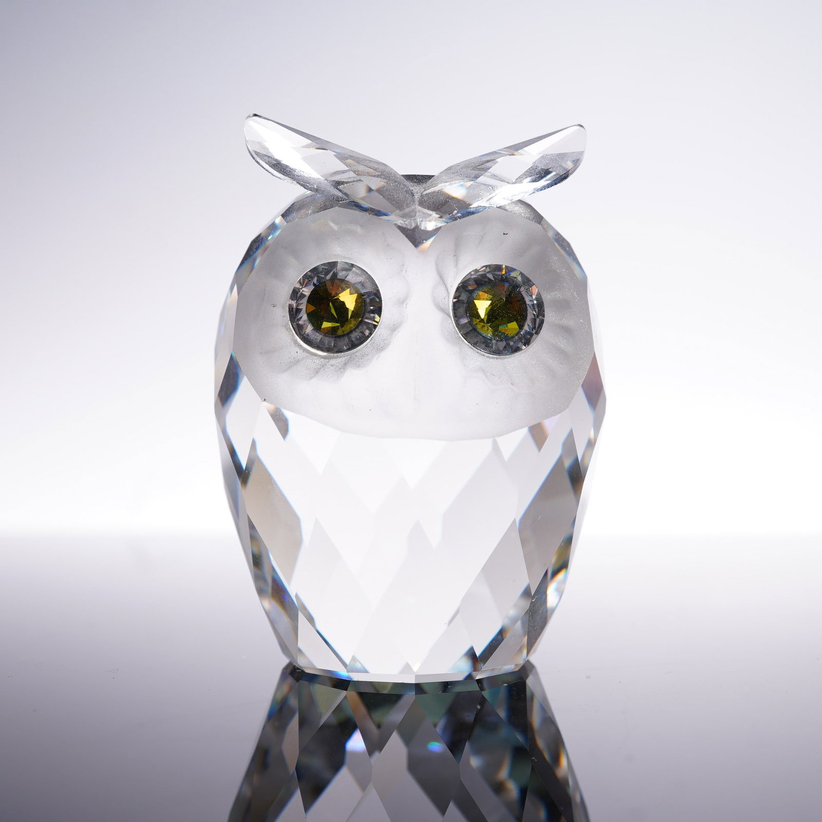 Swarovski Crystal Woodland Friends Owl Figurine: Swarovski crystal large owl figurine from the Woodland Friends collection, designed by Max Schreck. Features a clear faceted crystal body with a frosted face and beak, and striking green crystal eyes.