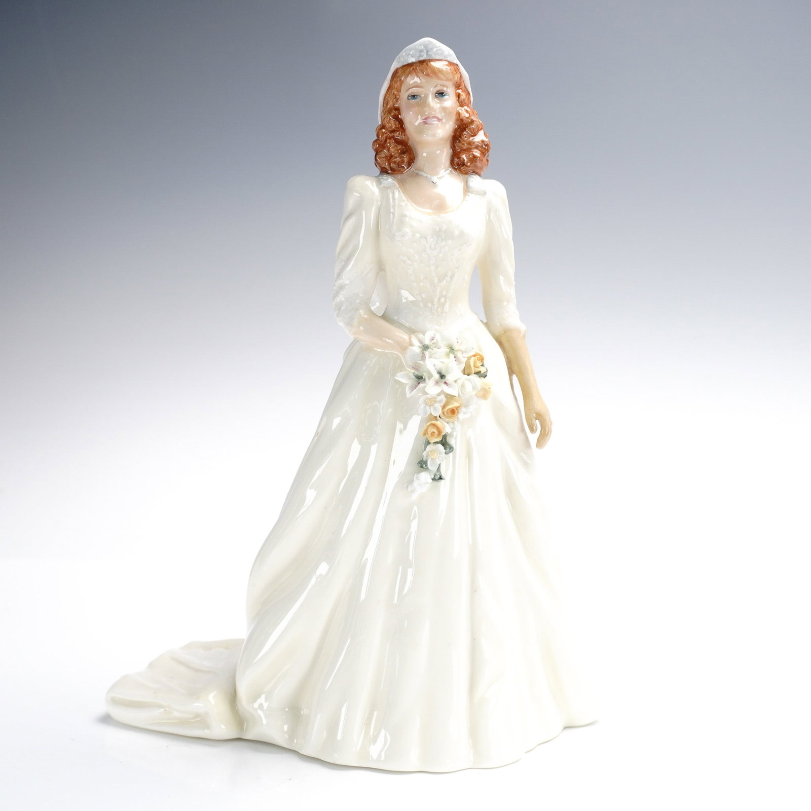 Royal Doulton Porcelain Figurine, The Duchess of York HN3086: Modeled by E.J. Griffiths and issued in 1986, The Duchess of York (HN3086) by Royal Doulton commemorates the wedding of Sarah Ferguson to Prince Andrew. The figurine depicts the Duchess in a classic b
