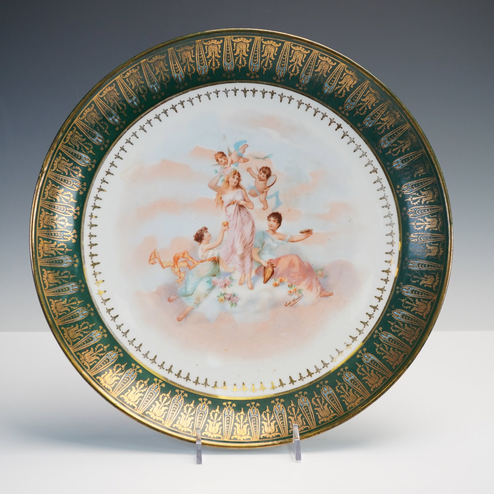Victoria Carlsbad Austria Porcelain Charger, Classical Scene w/Gilt Accent: This 12" porcelain charger by Victoria Carlsbad Austria features a neoclassical hand-painted scene depicting Greco-Roman maidens and cherubs among soft clouds. The central composition is encircled by 
