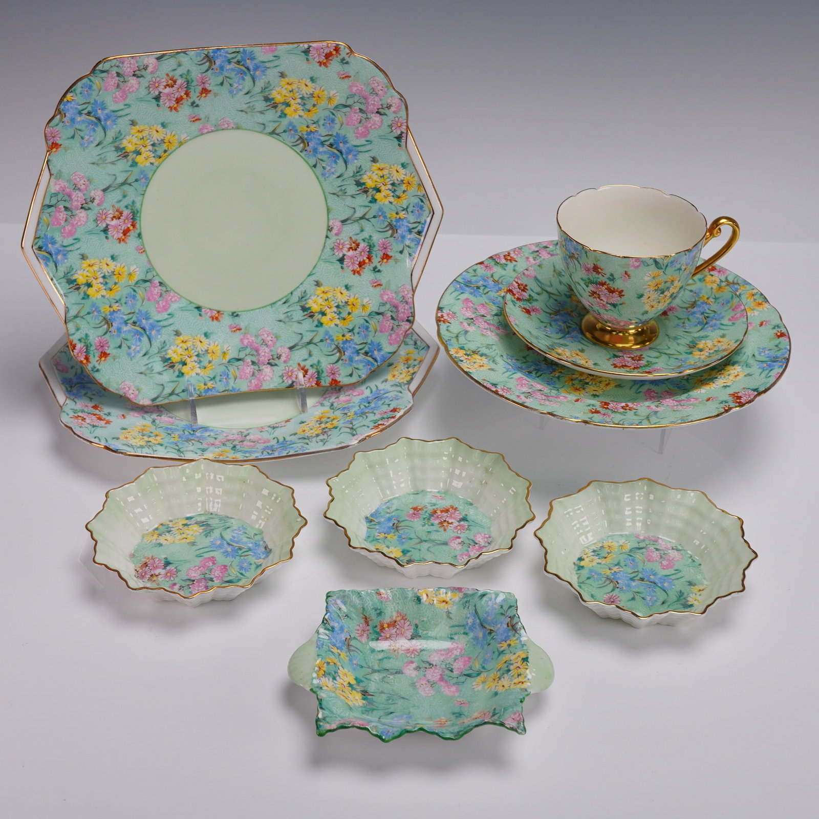 9pc Shelley England Bone China Tableware Melody Pattern: Nine-piece Shelley England fine bone china tableware set in the colorful Melody pattern. This coordinated grouping features a teacup and saucer, round and square dessert plates, four small nut bowls, 