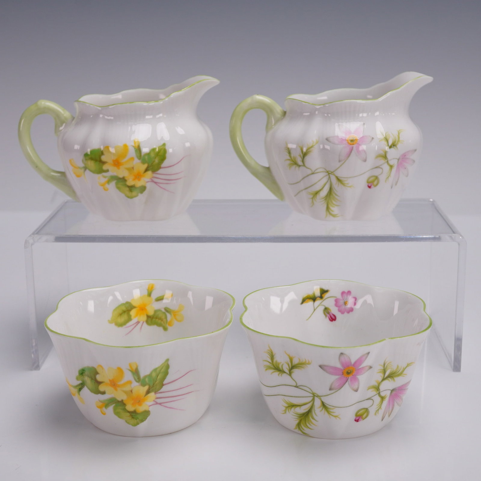 4pc Shelley Mini Creamers and Sugar Bowls, Wild Anemone & Primrose: Charming set of four Shelley fine bone china miniature table pieces in the Dainty shape, including two open sugar bowls and two small creamers. Each pair features a different floral pattern: Wild Anem