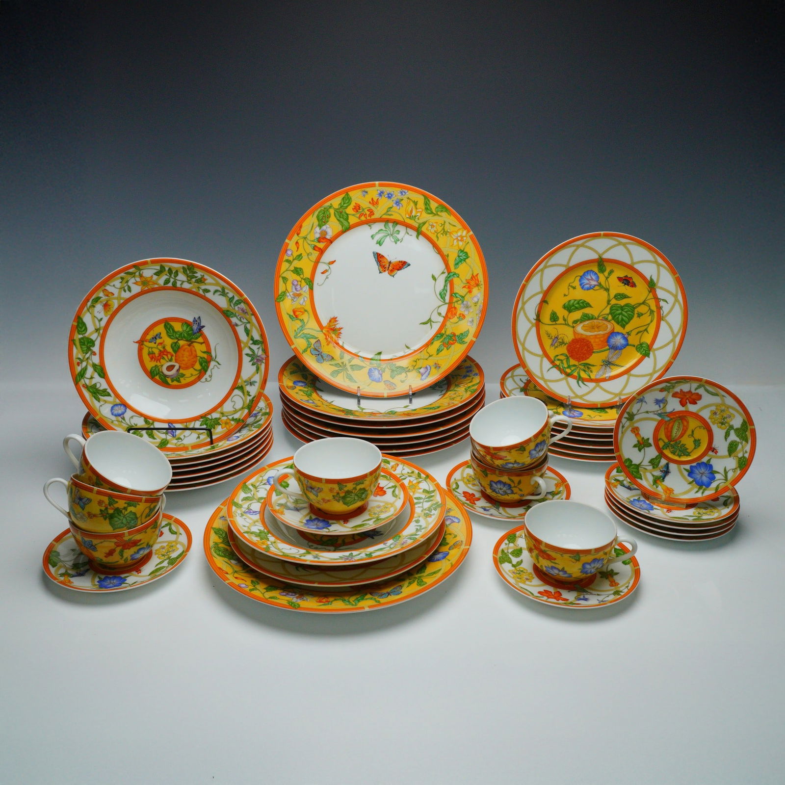 41pc Hermes La Siesta Porcelain Dinnerware, Serveware for 8: Vibrant 41-piece porcelain dinnerware set for 8 by Hermes in the La Siesta pattern. This set includes 8 dinner plates 11" dia., 8 salad plates 9" dia., 8 soup bowls 9" dia., 8 tea cups 2.25"H and 8 sa