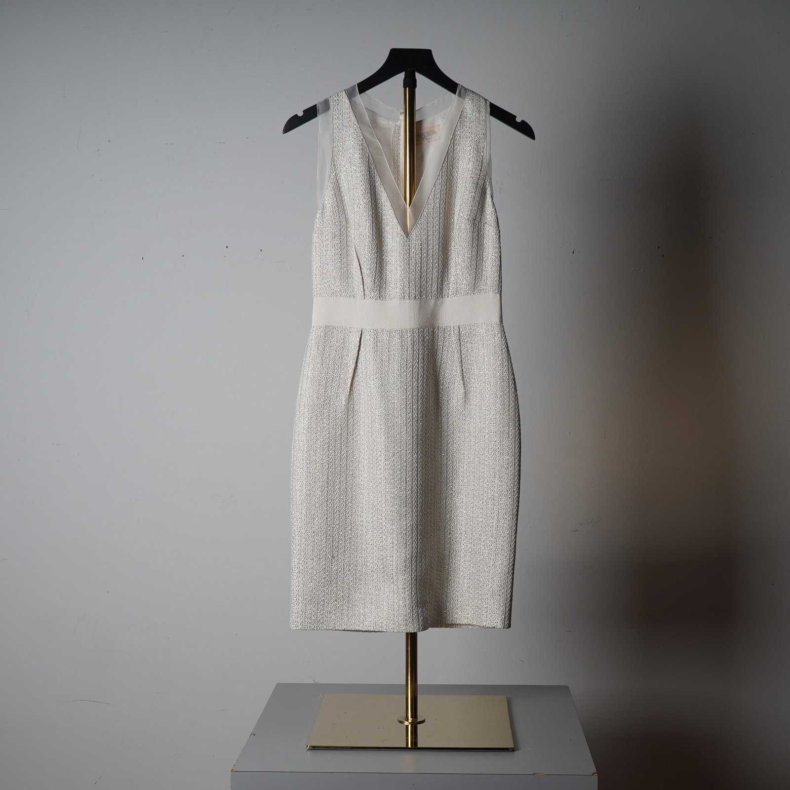 Giambattista Valli Paris Sleeveless Metallic Tweed Sheath Dress: Exude modern Parisian elegance with this refined sleeveless sheath dress by Giambattista Valli. Expertly crafted in Paris, this structured dress features a subtle metallic tweed fabric in ivory and si