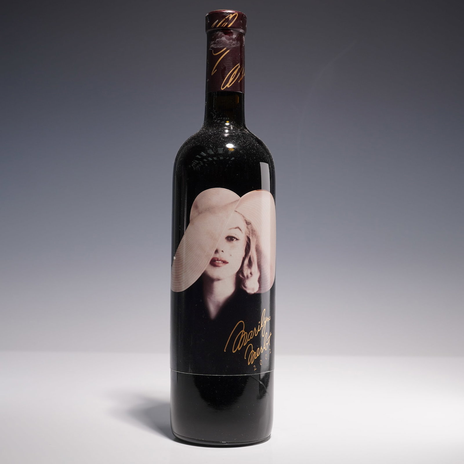 2002 Marilyn Merlot, Napa Valley 750ml Wine Bottle: A collector's 750ml bottle of 2002 Marilyn Merlot, a Napa Valley red wine celebrated for its striking label featuring an iconic portrait of Marilyn Monroe in a wide-brimmed hat. This vintage is a refi